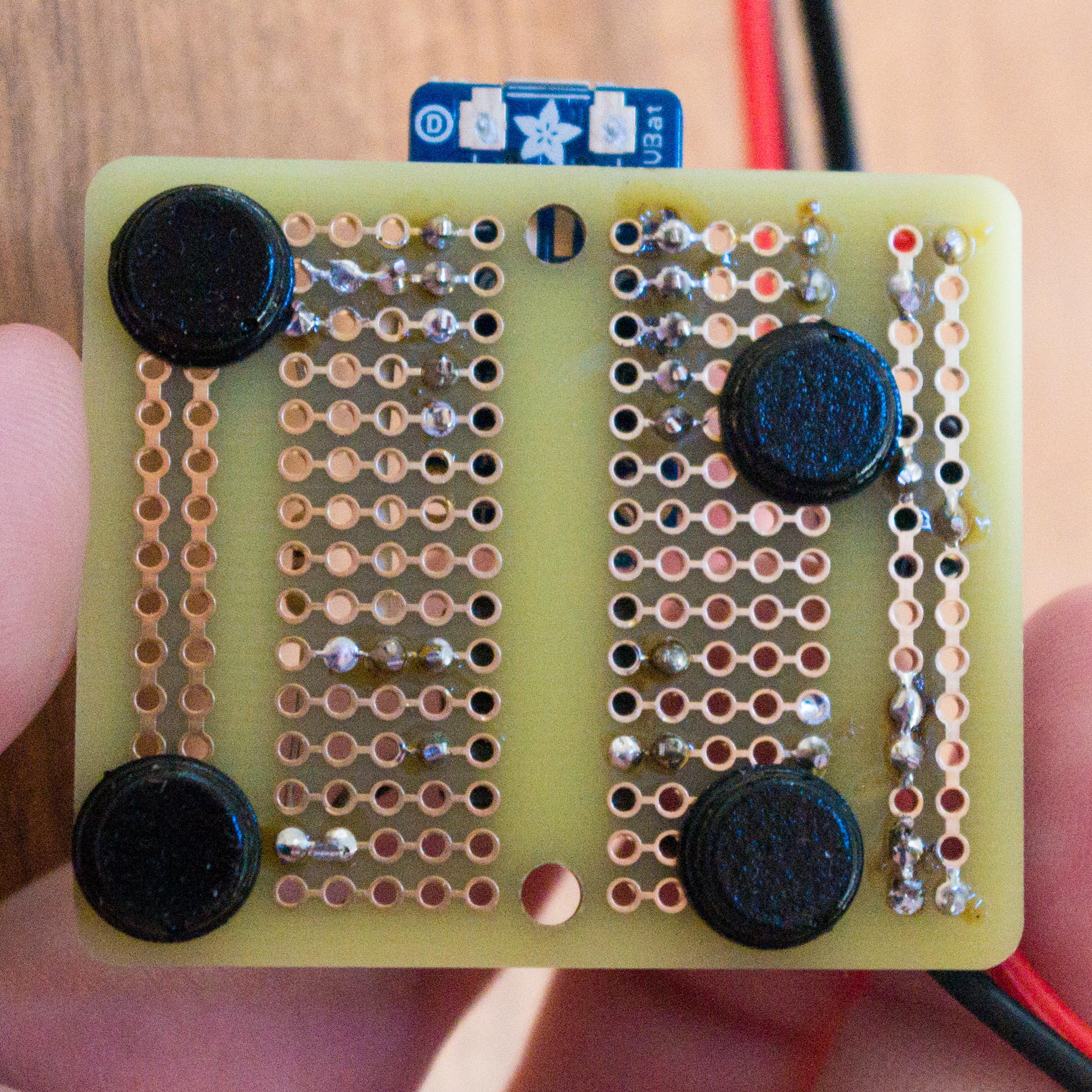 Adhesive feet on the bottom of the Perma-Proto board