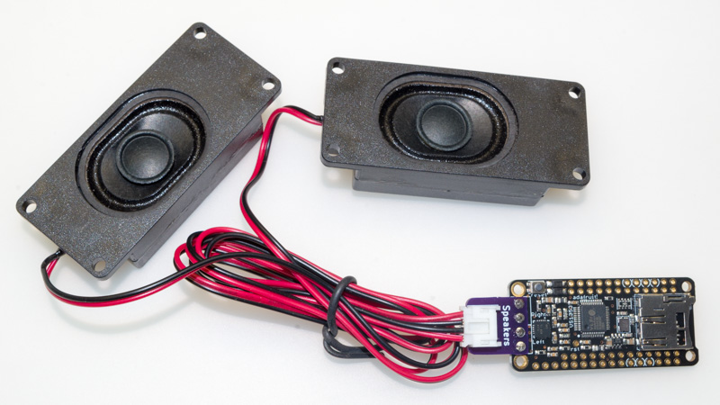 Music Maker featherwing connected to speakers via SpeakerAdapter board